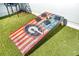 Close-up of a custom-designed cornhole game on the rooftop deck with artificial turf at 2424 Memorial Se Dr # 3, Atlanta, GA 30317