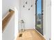 A stylish entryway featuring wood floors, a lantern, and decor hanging on the wall as you enter the home at 2424 Memorial Se Dr # 3, Atlanta, GA 30317