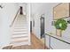 Bright hallway featuring a staircase, wood floors, and stylish decor leading to other parts of the home at 2424 Memorial Se Dr # 3, Atlanta, GA 30317