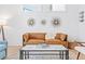 Cozy living room featuring a stylish leather sofa and sunburst mirrors at 2424 Memorial Se Dr # 3, Atlanta, GA 30317