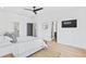 Main bedroom features a walk-in closet, a mounted television, an ensuite bathroom and light hardwood floors at 2424 Memorial Se Dr # 3, Atlanta, GA 30317
