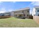 Backyard with grass and wood fence showcasing home's backyard patio at 2770 Westgate Park Dr, Loganville, GA 30052