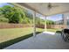 Covered backyard patio with ceiling fan, overlooking the lawn and wood fence at 2770 Westgate Park Dr, Loganville, GA 30052