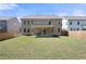 Backyard with grass and wood fence showcasing home's backyard patio at 2770 Westgate Park Dr, Loganville, GA 30052