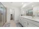Modern bathroom featuring double sinks, quartz counters, tiled floor and a glass-enclosed shower at 2770 Westgate Park Dr, Loganville, GA 30052