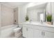 Bathroom featuring a double vanity, granite countertops and a bathtub with shower at 2770 Westgate Park Dr, Loganville, GA 30052