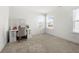 Bright bedroom featuring carpet, two windows, and vanity desk with chair at 2770 Westgate Park Dr, Loganville, GA 30052