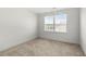 Clean and bright bedroom featuring neutral carpet, fresh paint and a bright window view at 2770 Westgate Park Dr, Loganville, GA 30052