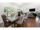 Bright dining room with wood floors, stylish furniture and view of the backyard at 2770 Westgate Park Dr, Loganville, GA 30052