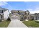 Charming two-story home featuring a two-car garage, manicured lawn, and inviting front porch at 2770 Westgate Park Dr, Loganville, GA 30052