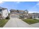 Charming, two-story home featuring a two-car garage, well-maintained lawn, and inviting front porch at 2770 Westgate Park Dr, Loganville, GA 30052