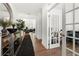Bright foyer with hardwood floors, decorative mirror, and an office with french doors at 2770 Westgate Park Dr, Loganville, GA 30052