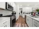 Modern kitchen with stainless steel appliances, white cabinetry, and ample counter space at 2770 Westgate Park Dr, Loganville, GA 30052