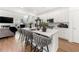 Stylish kitchen with an island, bar stools, stainless appliances, and open to the living area at 2770 Westgate Park Dr, Loganville, GA 30052