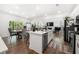 Bright open-concept kitchen featuring an island, stainless appliances, and a dining area at 2770 Westgate Park Dr, Loganville, GA 30052