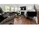 Comfortable living room with a fireplace, large windows, stylish sofas and a mirrored coffee table at 2770 Westgate Park Dr, Loganville, GA 30052
