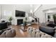 Spacious living room with high ceilings, a fireplace, elegant furniture, and a staircase at 2770 Westgate Park Dr, Loganville, GA 30052