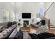 Elegant living room with high ceilings, fireplace, large windows and staircase at 2770 Westgate Park Dr, Loganville, GA 30052