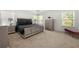Spacious main bedroom featuring stylish furnishings and plenty of natural light from the windows at 2770 Westgate Park Dr, Loganville, GA 30052