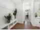 Clean mud room with built-in bench, coat hooks, and view into the living area at 2770 Westgate Park Dr, Loganville, GA 30052