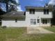 Home's backyard features a spacious lawn and a concrete patio area at 3870 Spring Moss Cir, Snellville, GA 30039