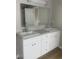Bathroom featuring double sinks and a large mirror, providing ample space and modern amenities at 3870 Spring Moss Cir, Snellville, GA 30039