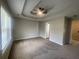 Large bedroom with carpet, a ceiling fan, tray ceilings and plenty of natural light at 3870 Spring Moss Cir, Snellville, GA 30039