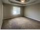 Spacious carpeted bedroom with modern ceiling fan and natural light from the window at 3870 Spring Moss Cir, Snellville, GA 30039