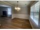 Sunlit dining area with wainscoting, neutral paint, and wood-look floors at 3870 Spring Moss Cir, Snellville, GA 30039