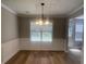 Cozy dining area with wainscoting, contemporary light fixture, and large window at 3870 Spring Moss Cir, Snellville, GA 30039
