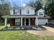 Charming two-story home featuring a brick and vinyl exterior and a well-manicured lawn at 3870 Spring Moss Cir, Snellville, GA 30039