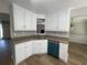 Bright kitchen featuring white cabinets, granite countertops, laminate flooring, and stainless steel sink at 3870 Spring Moss Cir, Snellville, GA 30039