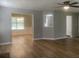 Spacious living room featuring wood floors, a ceiling fan, and views into other rooms at 3870 Spring Moss Cir, Snellville, GA 30039