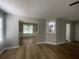 Open living room showcasing wood floors, dining area, and natural light at 3870 Spring Moss Cir, Snellville, GA 30039