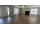 Bright living room featuring a fireplace, laminate floors, and natural light from multiple windows at 3870 Spring Moss Cir, Snellville, GA 30039