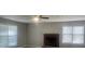 Living room featuring neutral walls, laminate floors, a brick fireplace and two windows at 3870 Spring Moss Cir, Snellville, GA 30039