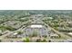 Aerial view showcases shopping centers, commercial buildings, and parking lots, interspersed with greenery and roads at 640 Saddle Ridge Trce, Roswell, GA 30076