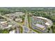 Aerial view of a commercial area with multiple buildings, roads, parking lots, and some green spaces and trees at 640 Saddle Ridge Trce, Roswell, GA 30076