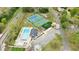 Aerial view of community amenities includes a swimming pool, tennis courts, basketball courts, playground, and parking areas at 640 Saddle Ridge Trce, Roswell, GA 30076