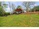 Lush backyard with mature trees, sloping lawn, and privacy at 640 Saddle Ridge Trce, Roswell, GA 30076