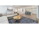 Finished basement with large sectional, decorative rug, and adjacent kitchen area with bar seating at 640 Saddle Ridge Trce, Roswell, GA 30076