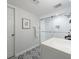 Bathroom featuring a glass enclosed shower, modern vanity, and stylish tile flooring with a circular mirror at 640 Saddle Ridge Trce, Roswell, GA 30076