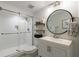 Bright bathroom featuring a glass-enclosed shower with white subway tile and modern vanity with round mirror at 640 Saddle Ridge Trce, Roswell, GA 30076