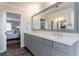 Elegant bathroom featuring double sinks, gray cabinetry, and access to the bedroom at 640 Saddle Ridge Trce, Roswell, GA 30076