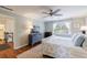 Cozy bedroom featuring a ceiling fan, natural light, and hardwood flooring at 640 Saddle Ridge Trce, Roswell, GA 30076