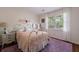 Charming bedroom with a large window, plush purple carpet, and unique metal bed frame at 640 Saddle Ridge Trce, Roswell, GA 30076
