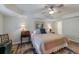 Bedroom featuring a comfortable bed, ceiling fan, and traditional decor, complemented by a decorative rug at 640 Saddle Ridge Trce, Roswell, GA 30076