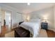 This cozy bedroom features hardwood floors and a comfy bed with white bedding at 640 Saddle Ridge Trce, Roswell, GA 30076