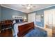 This is a comfortable bedroom with a large window, dark wood furniture, and hardwood floors at 640 Saddle Ridge Trce, Roswell, GA 30076