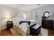 Cozy bedroom features hardwood floors, white bedding, and a dresser with ornate mirror at 640 Saddle Ridge Trce, Roswell, GA 30076